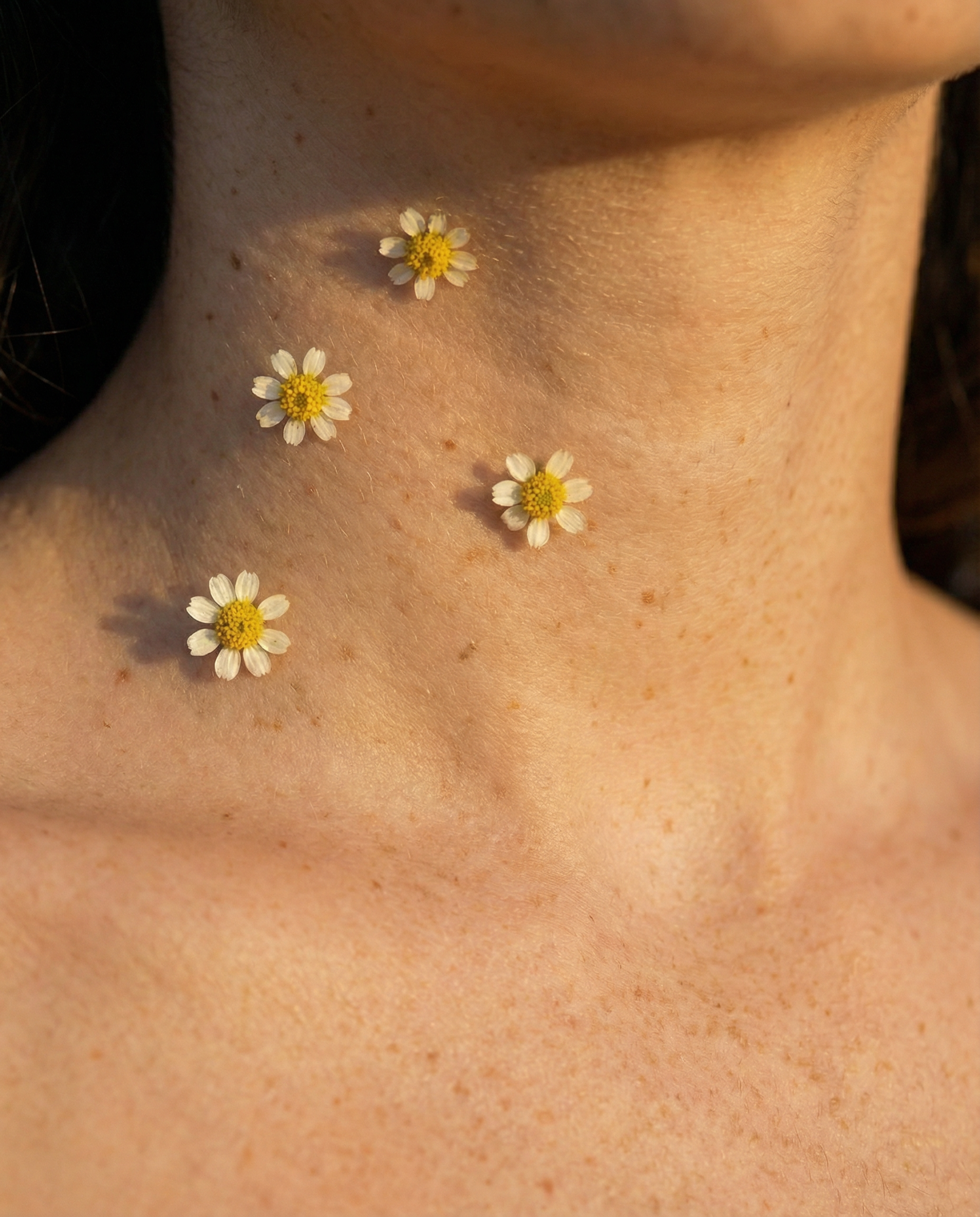Neck and décolleté with flowers, editorial image linked to skin firmness and elasticity
